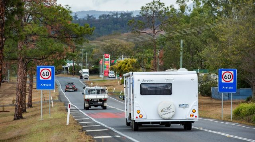 White caravan driving on a regional road
